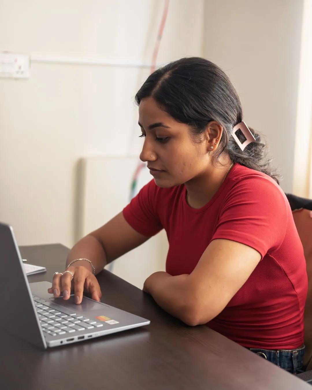 A Cybersecurity student working on her laptop