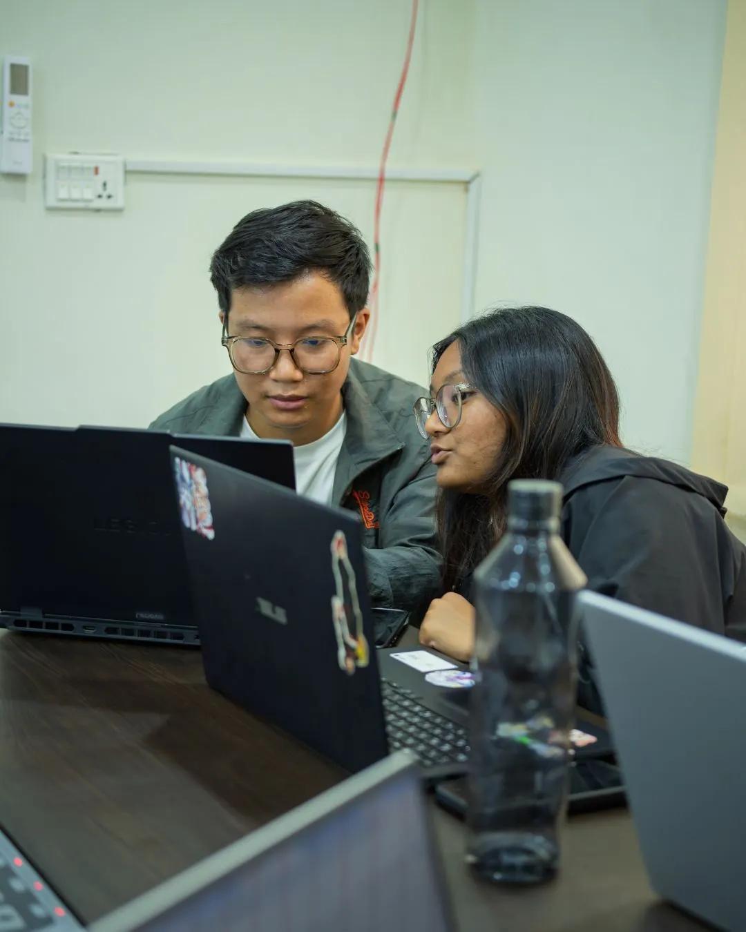 Two students pairing on a laptop