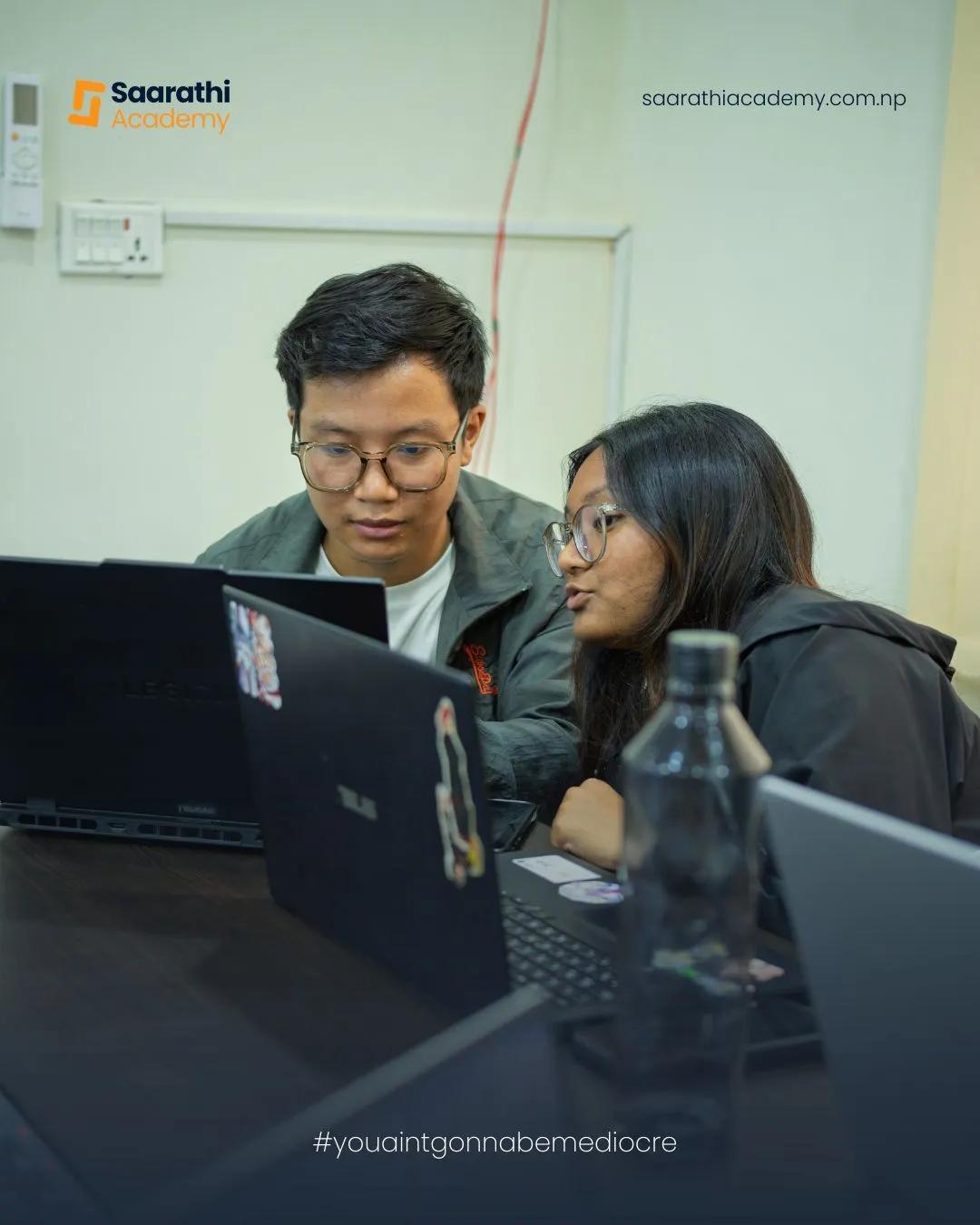 Two students pairing on a laptop