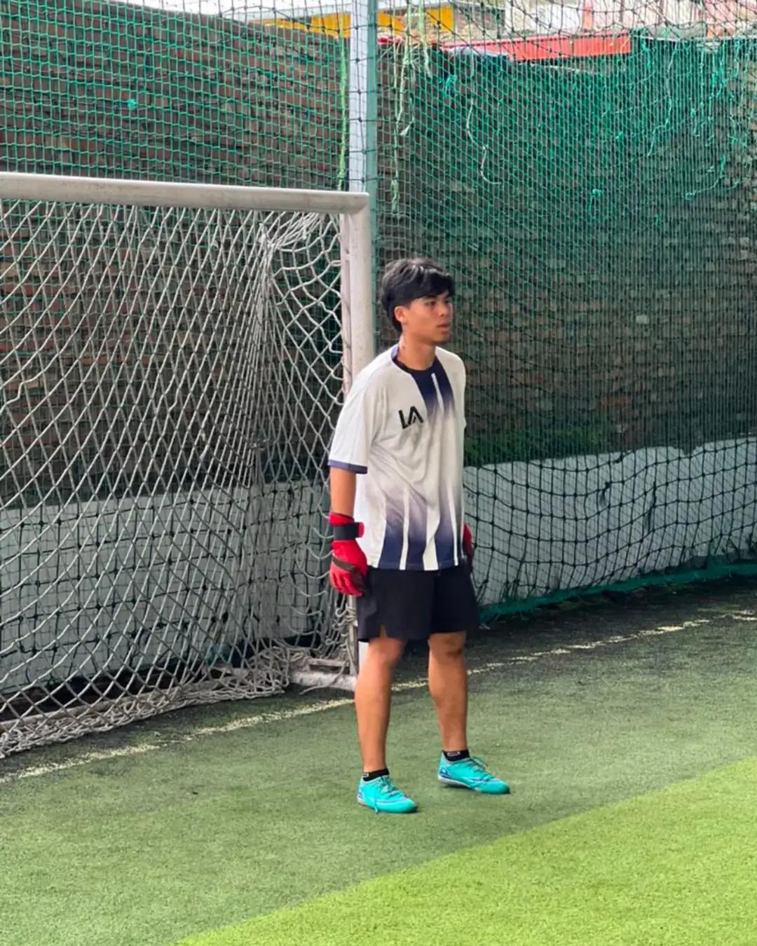 A student keeping goal