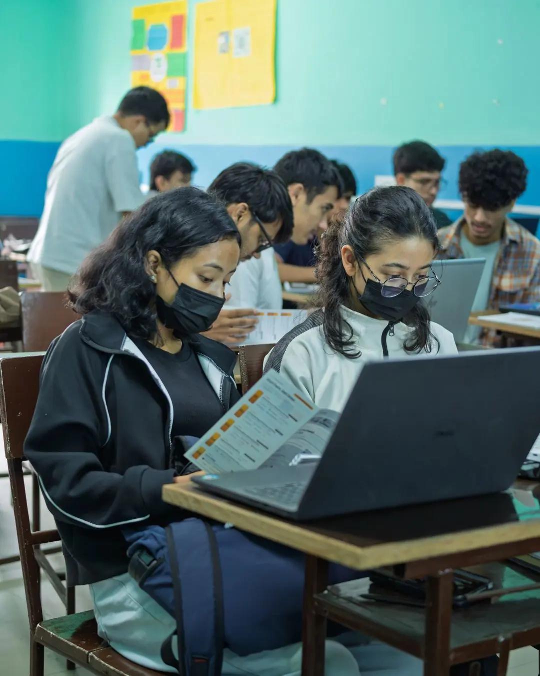 A student walking a classmate through his screen