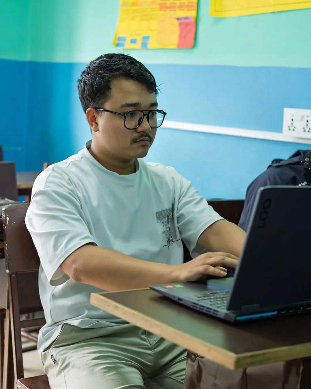 The trainer helping a student at her desk